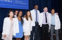 six dental students wearing white coats